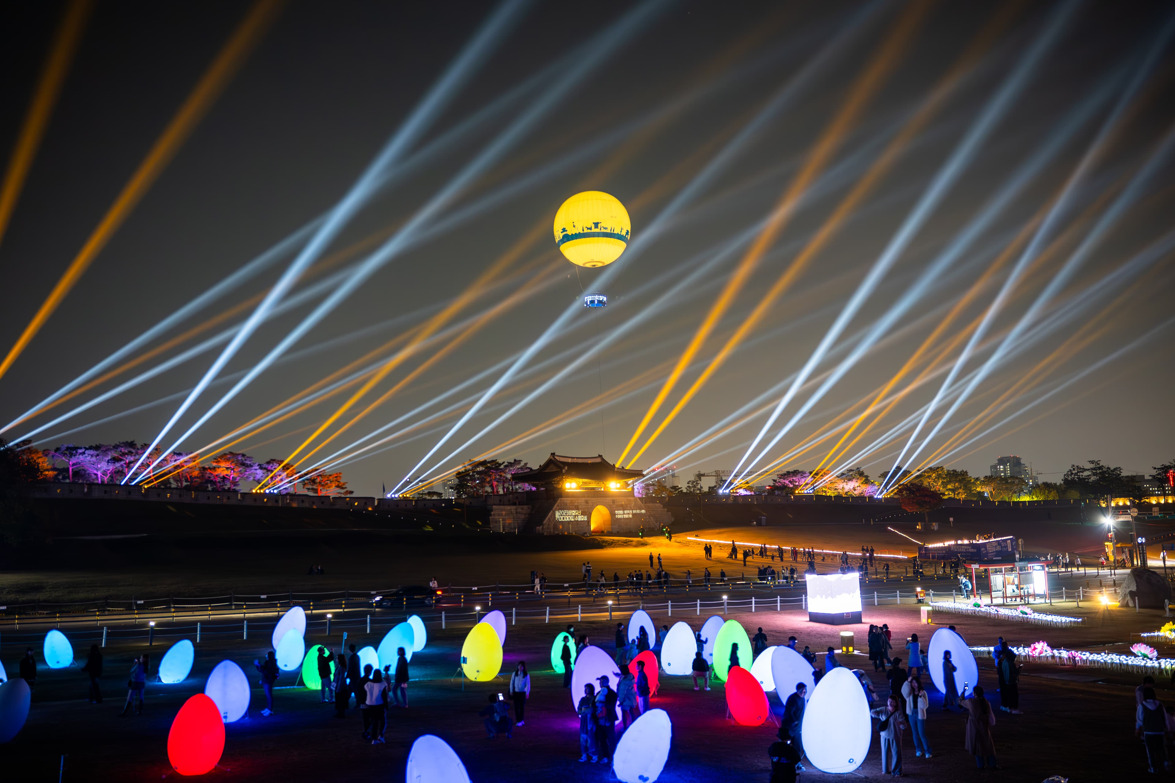 Night festival with light beams and balloon